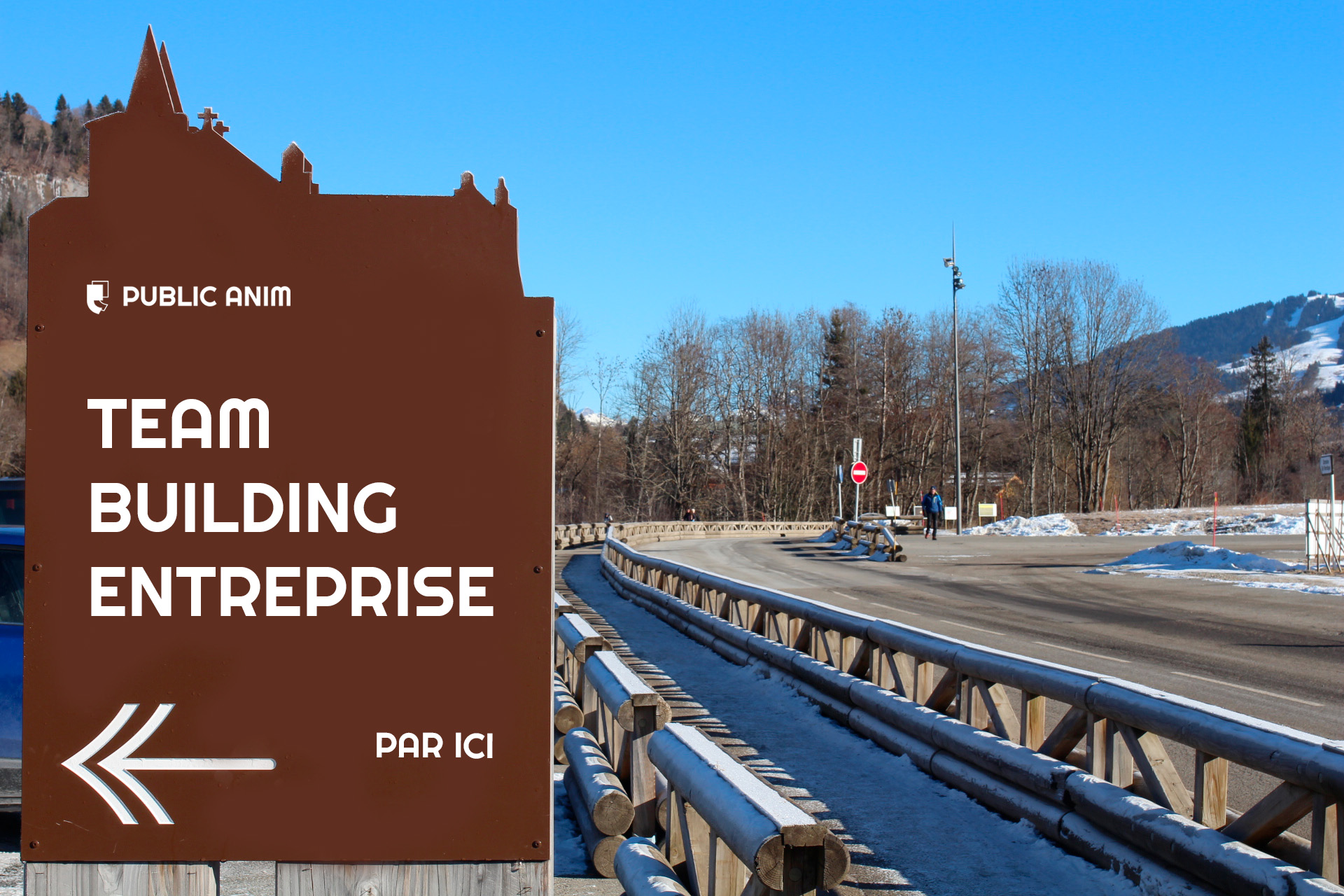 Paysage de montagne avec un panneau de ville ou est afficher la direction d'un team building