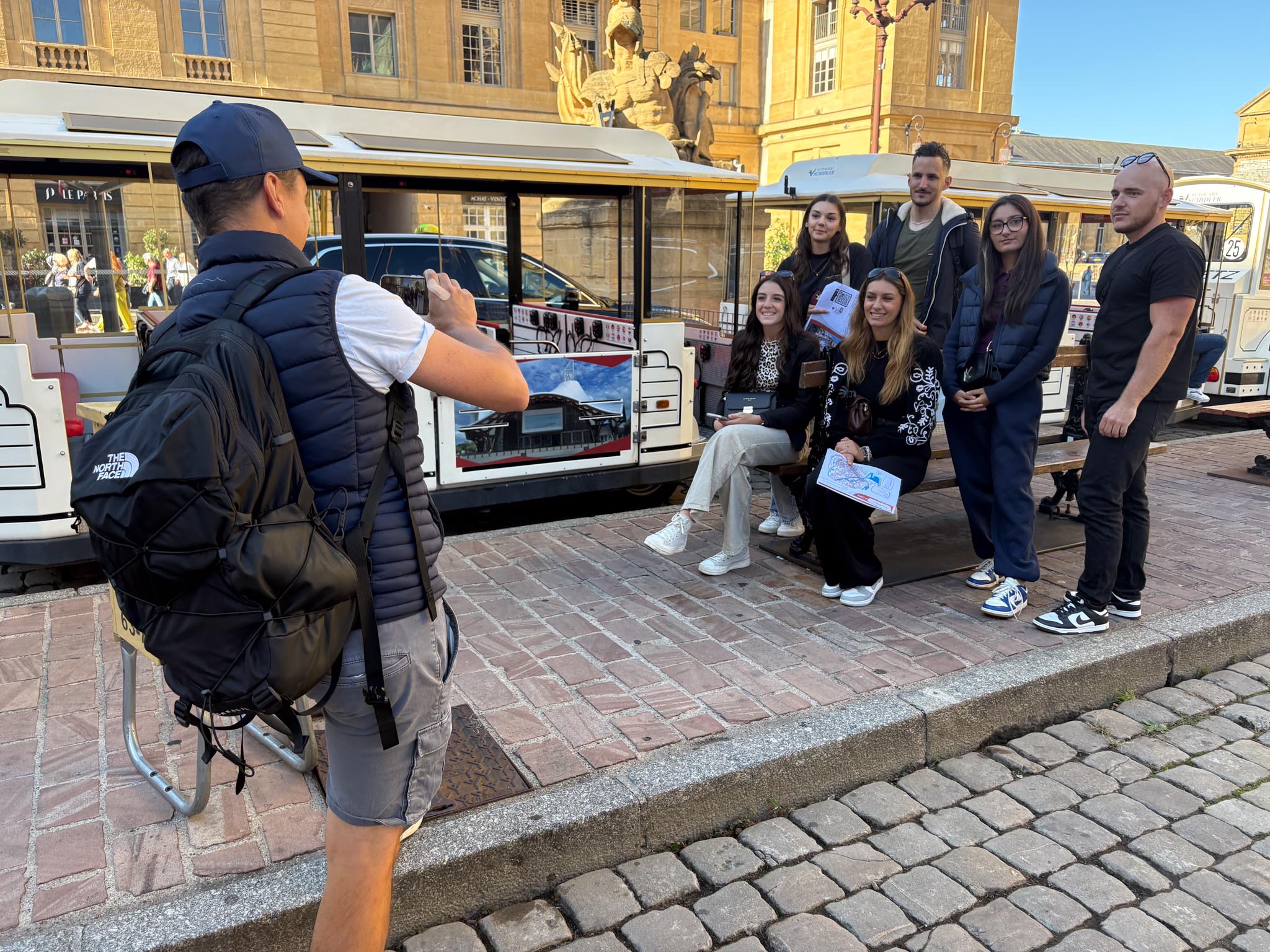 un animateur prend en photo en centre-ville une équipe d'un team building