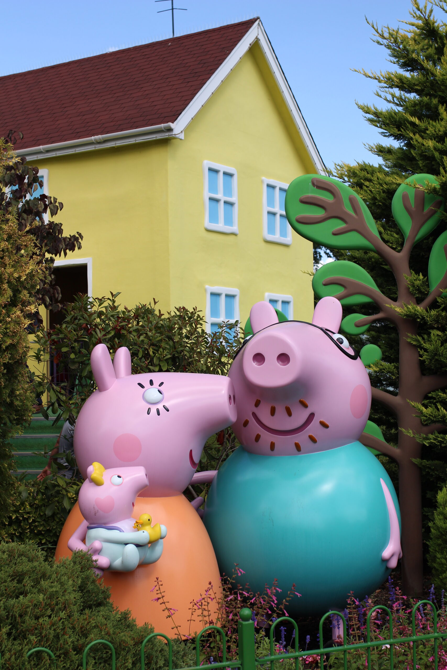 three Peppa Pig characters as statues